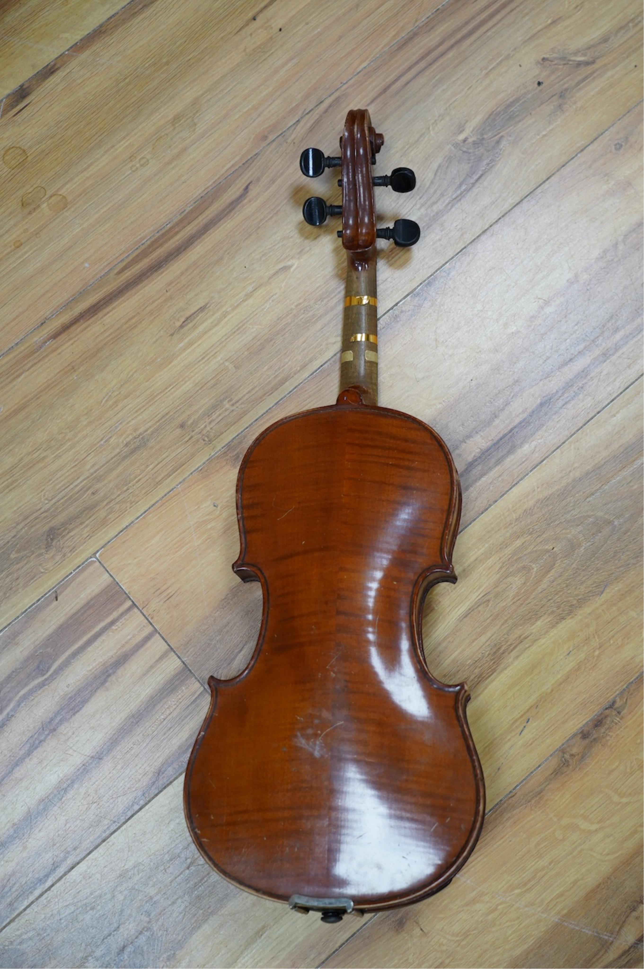 Two late 19th or early 20th century violins, one with case, back of largest measures 36cm. Condition - poor to fair